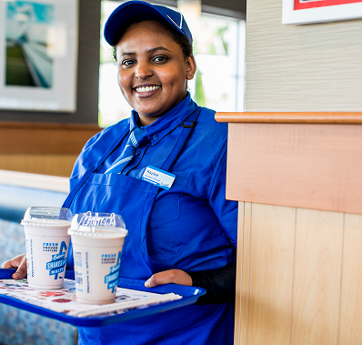 Employee in blue uniform with beverages