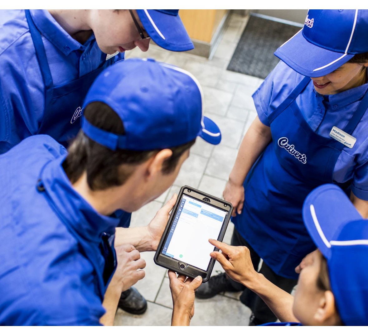 Group of employees in blue uniforms meeting